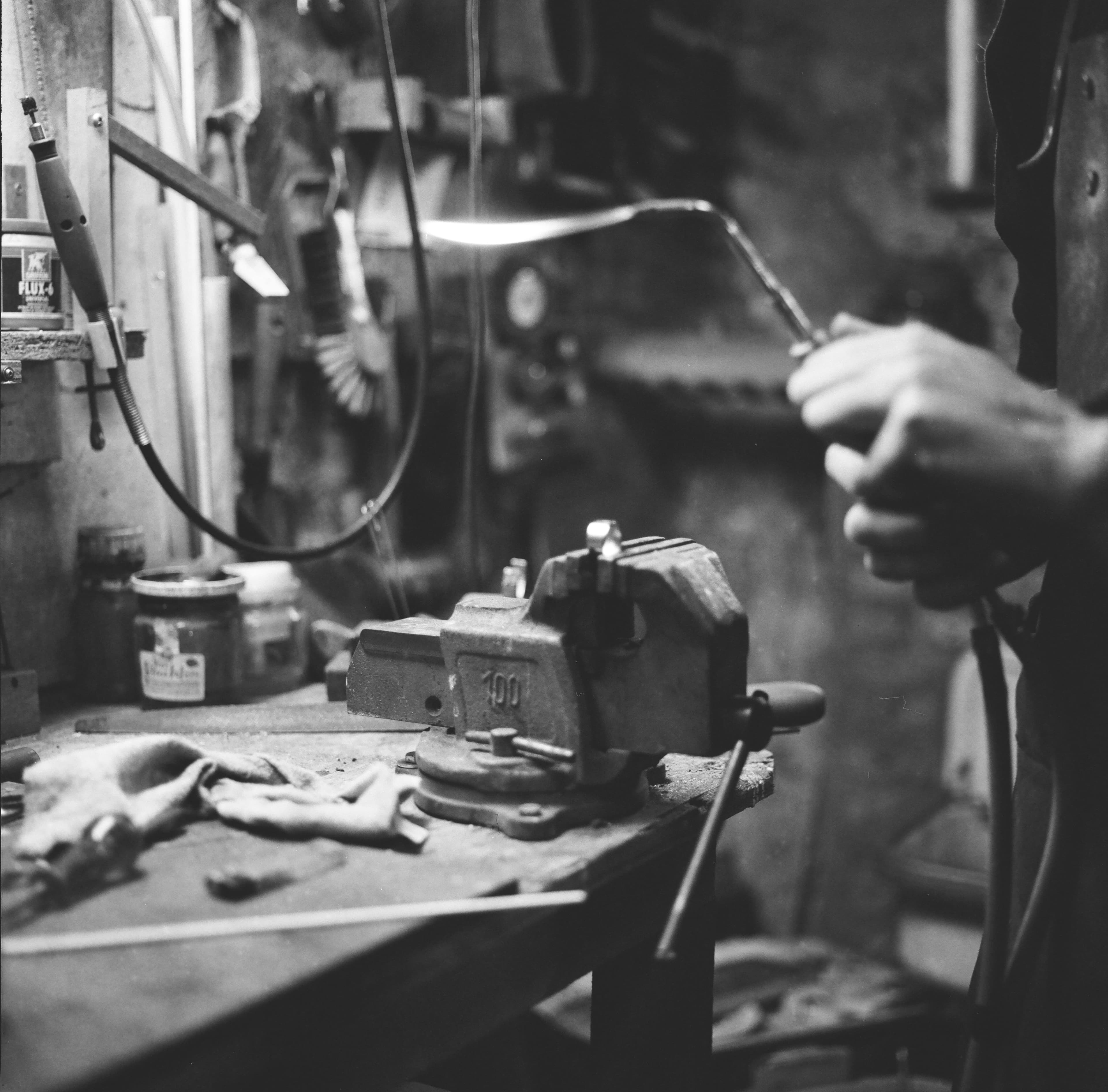 Shaping metal by hand at the workbench